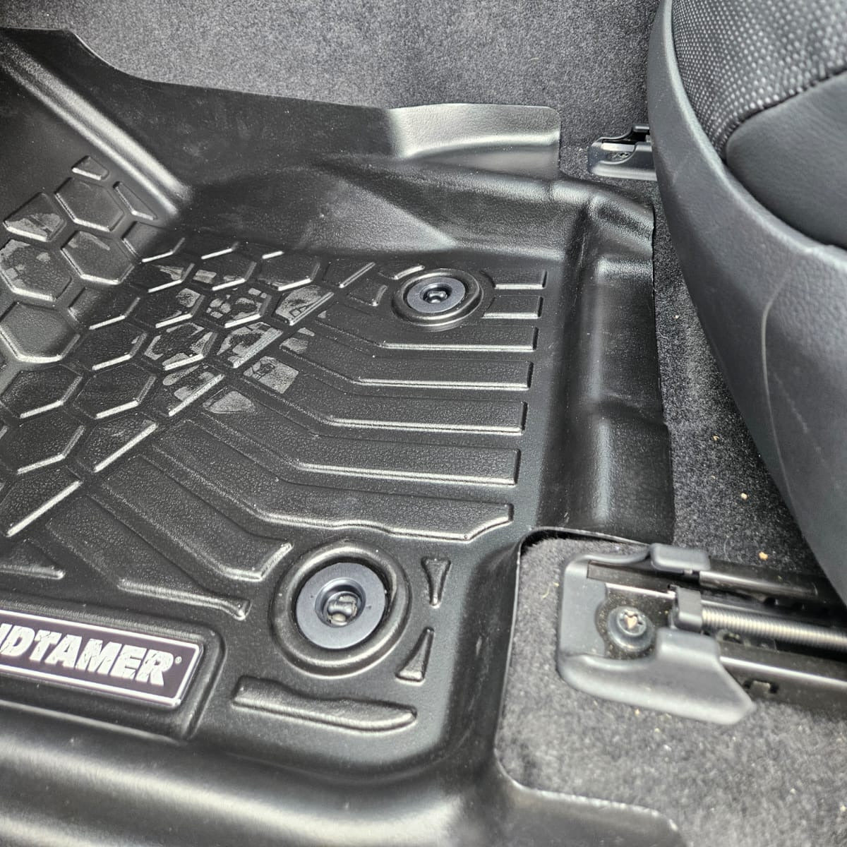 Car floor mat with brand logo on a car interior background