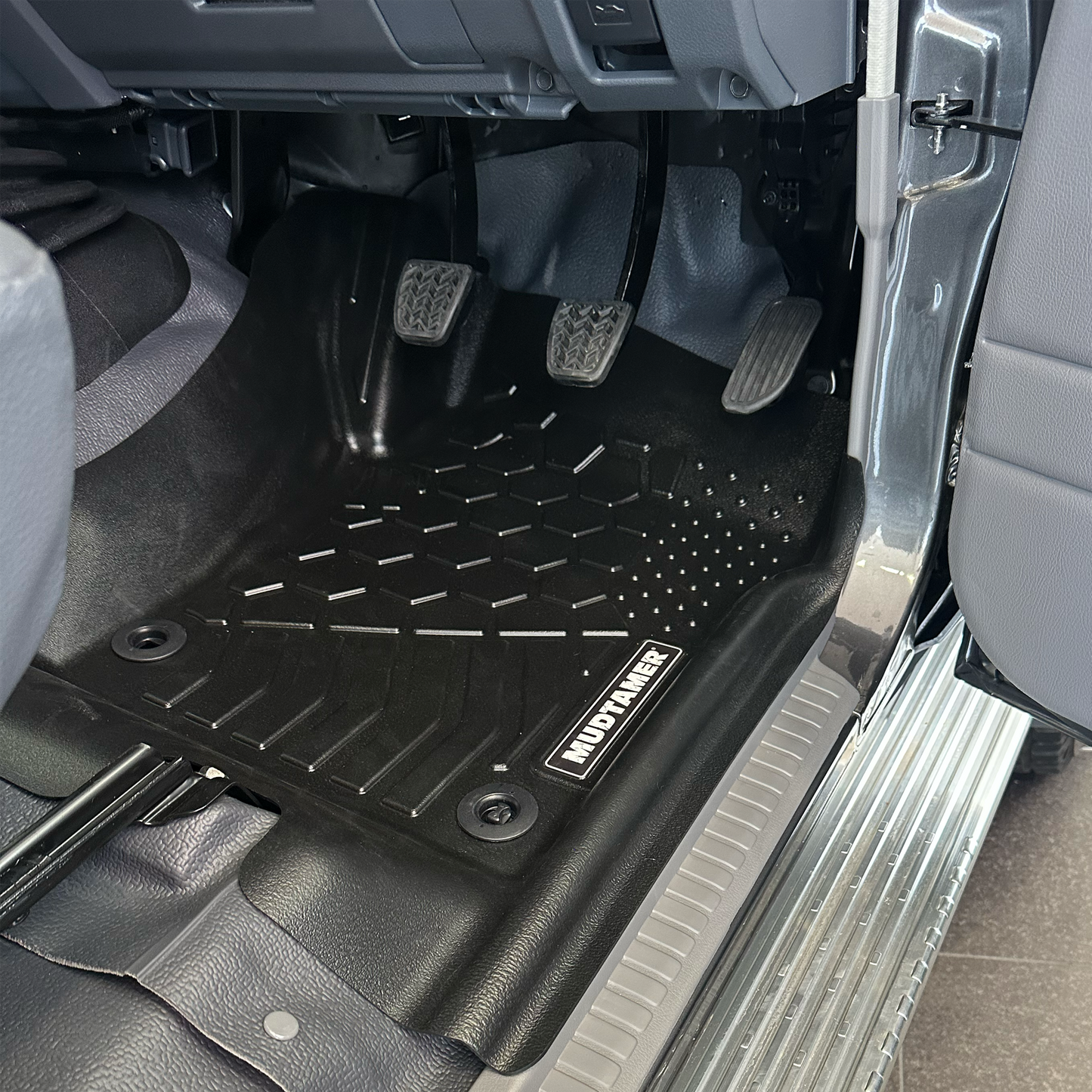 MUDTAMER driver's side floor mat installed in a Toyota Landcruiser 79 Series Dual Cab