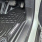 Car floor mat with 'MudTamer' branding inside a vehicle.