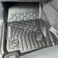 Car floor mat with tread pattern and brand logo on a car interior background