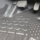 Car interior with a detailed view of the floor mat and pedals.